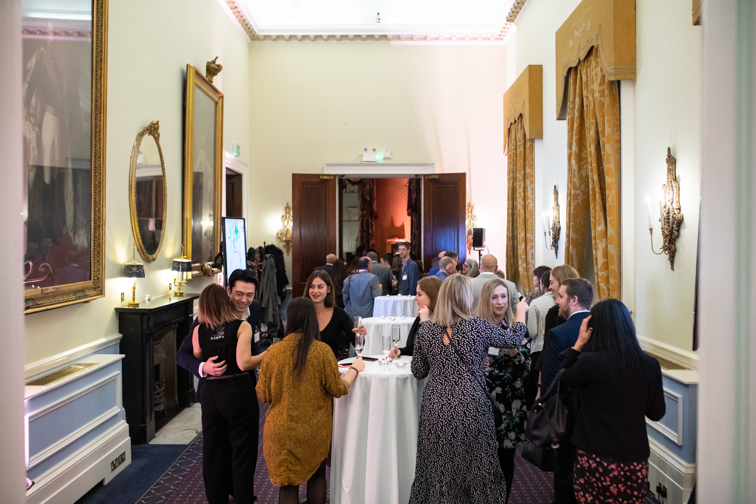 Vibrant networking event at St James Rooms, 116 Pall Mall, with elegant decor and warm lighting.