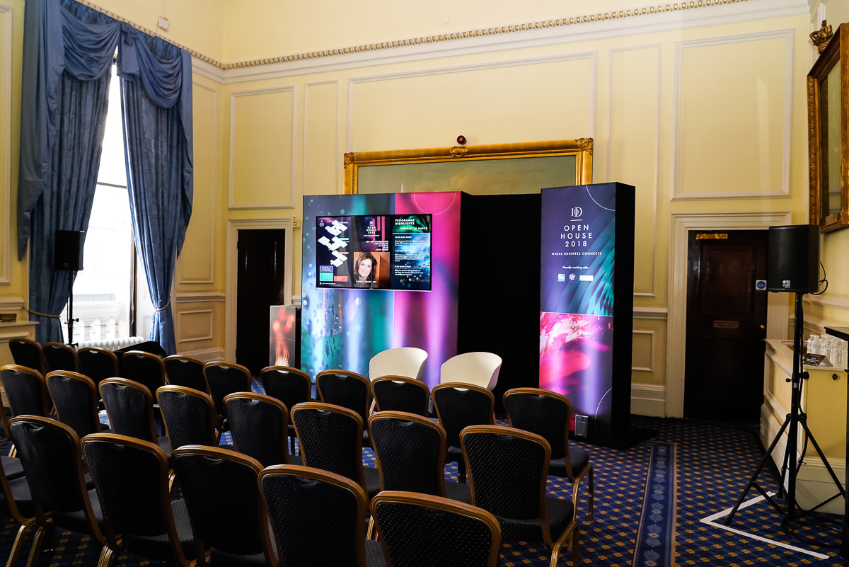 St James Rooms event space with sleek stage setup for corporate meetings and presentations.
