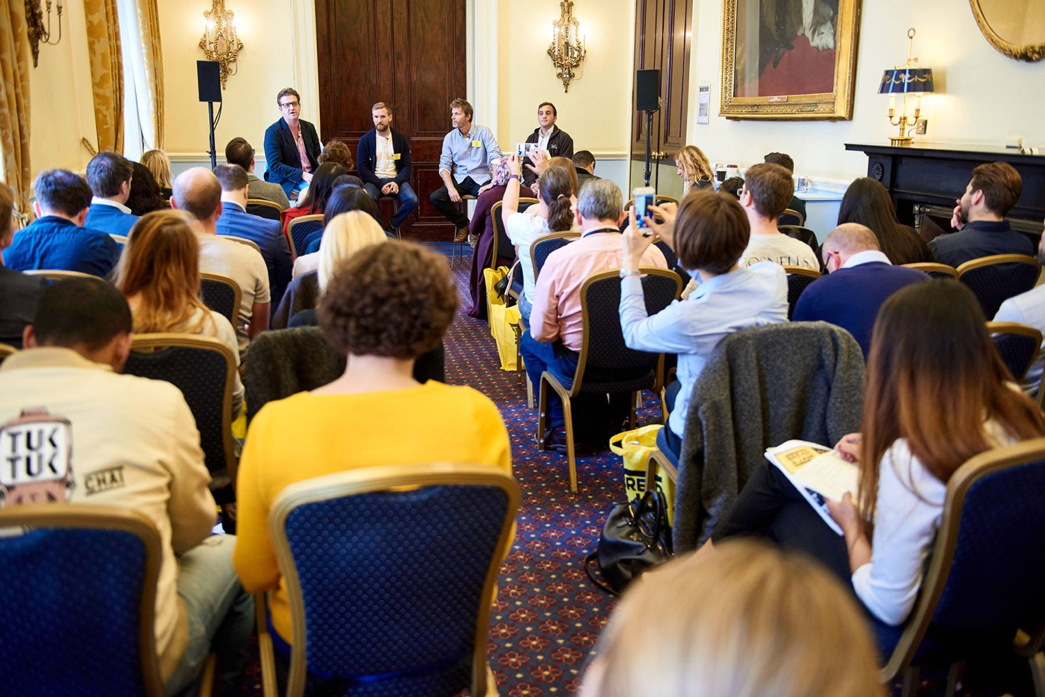 Panel discussion at St James Rooms, 116 Pall Mall, featuring engaged speakers and audience.