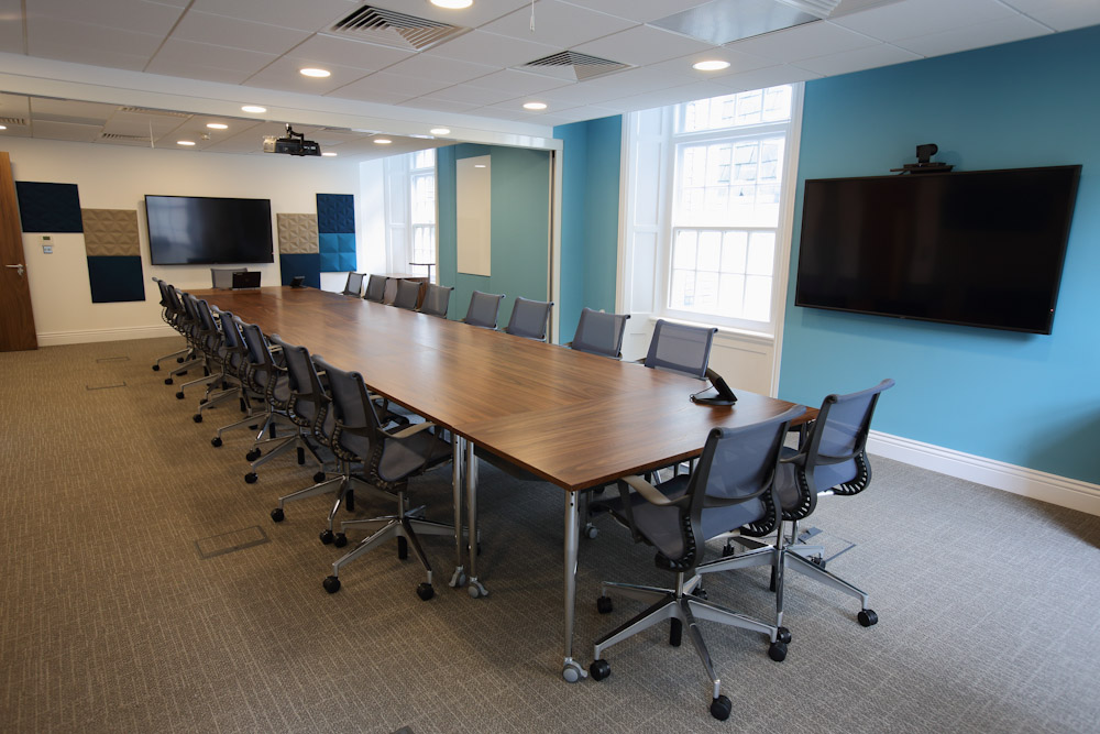 Modern conference room at IoD Academy, featuring a sleek table for meetings and presentations.