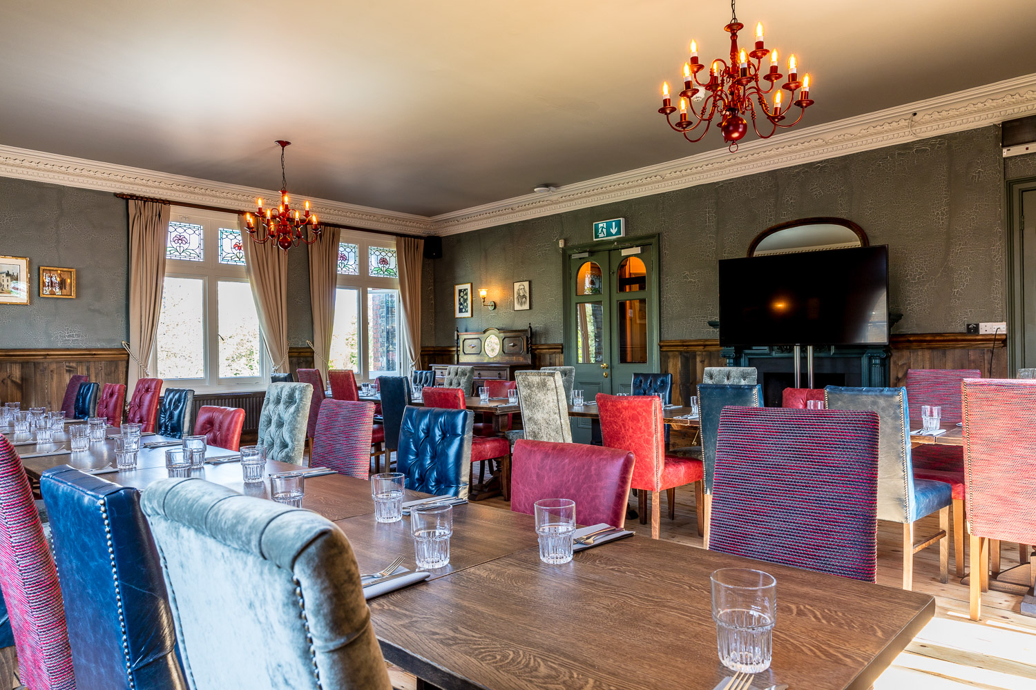 Stylish Trinity Room with colorful chairs, perfect for workshops and corporate meetings.