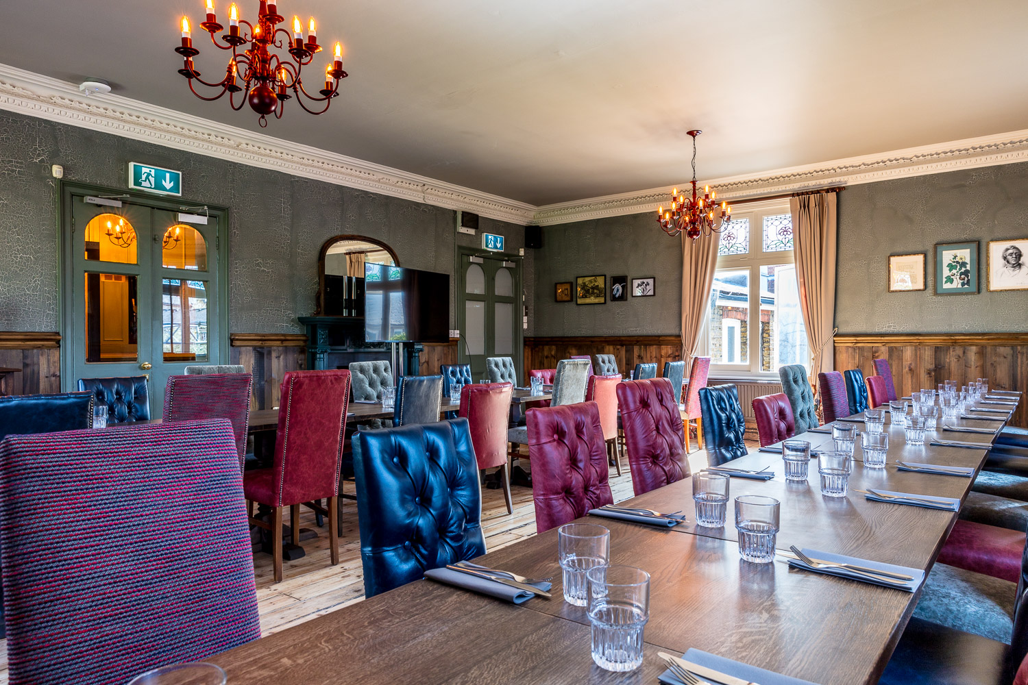 Trinity Room dining space with colorful chairs for corporate events and intimate gatherings.