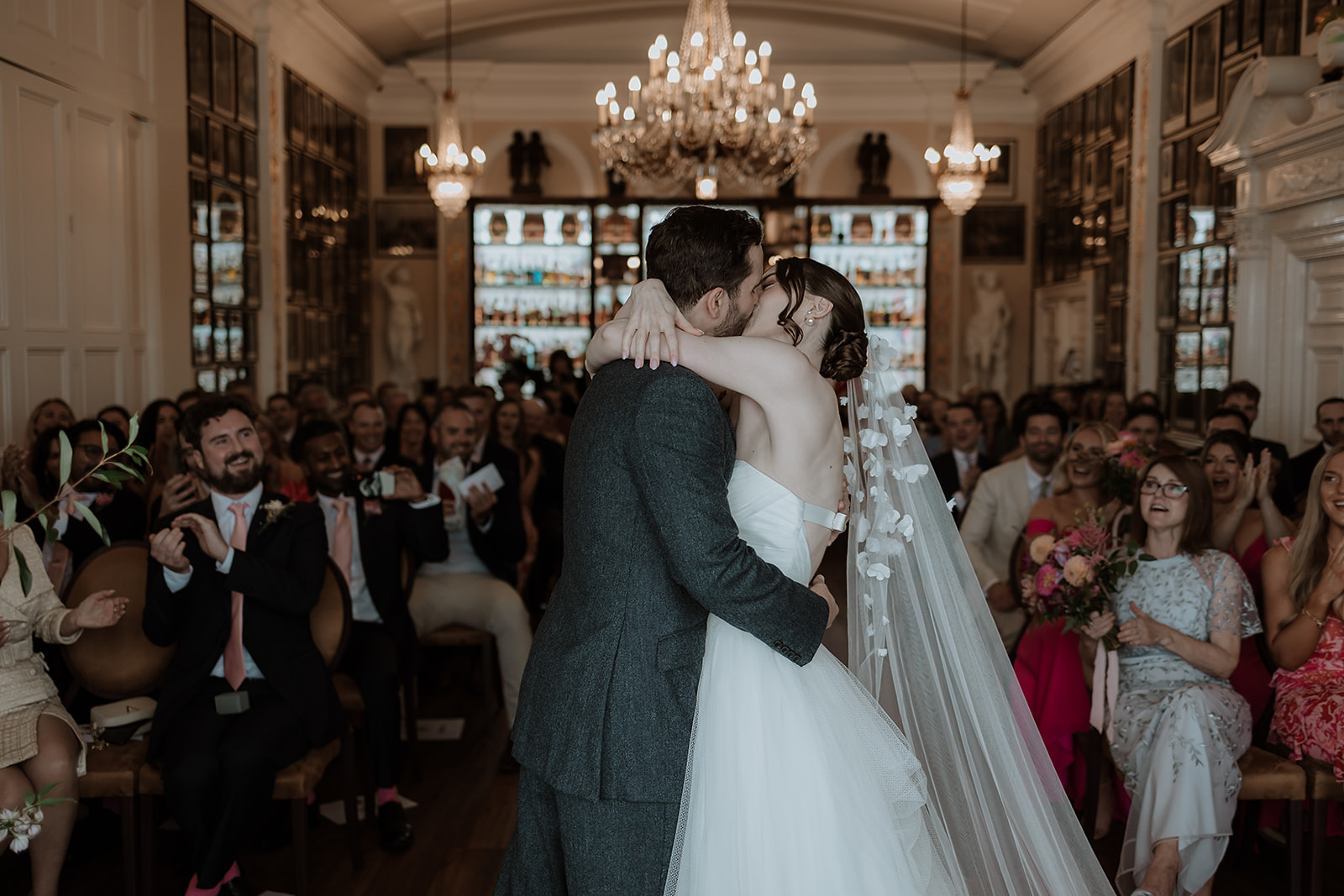 Intimate wedding ceremony in Nelson Room, Trafalgar Tavern, capturing couple's first kiss.