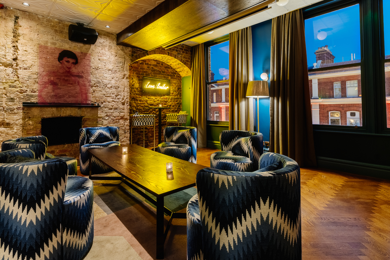 Stylish cocktail bar with stone walls, perfect for networking events and gatherings.