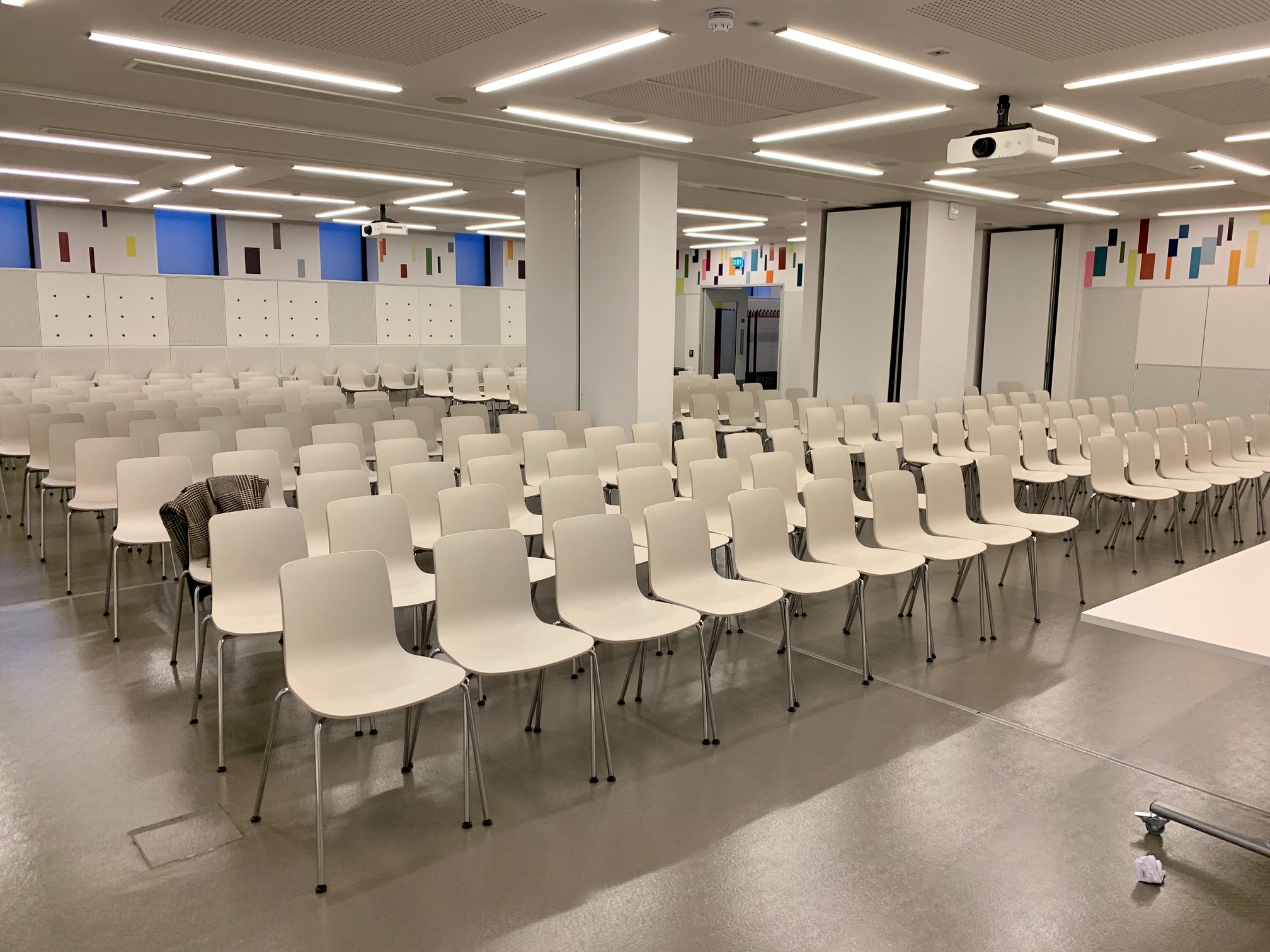 Foyle Centre meeting room with white chairs, ideal for workshops and presentations.
