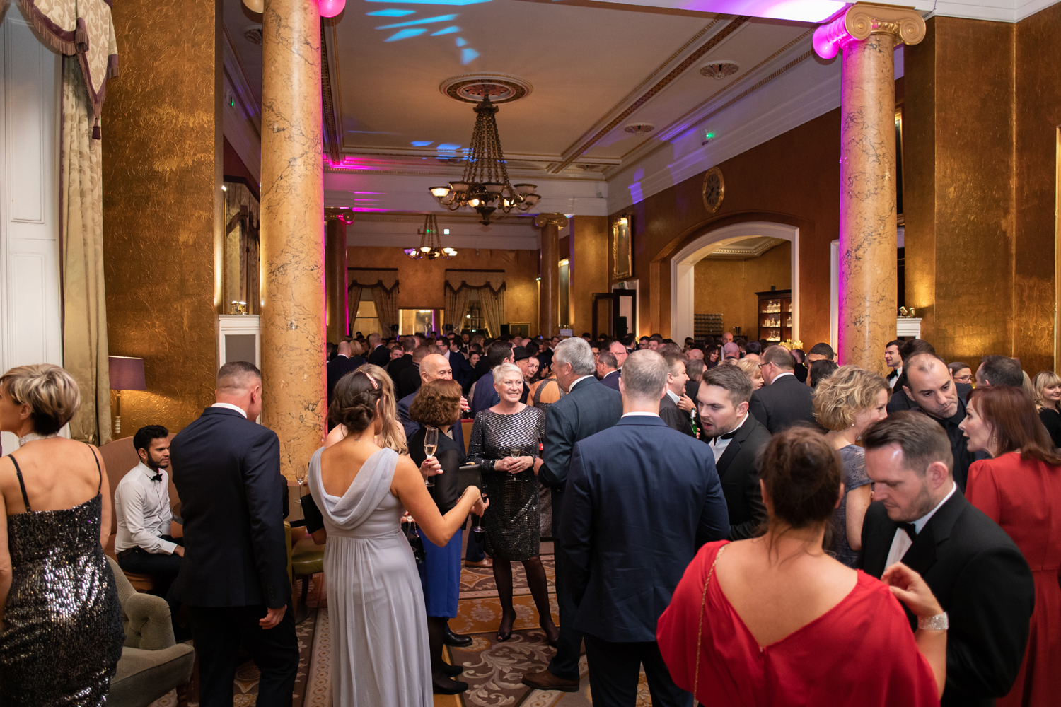 Vibrant networking event in Carlton Room, 116 Pall Mall with elegant decor and warm lighting.