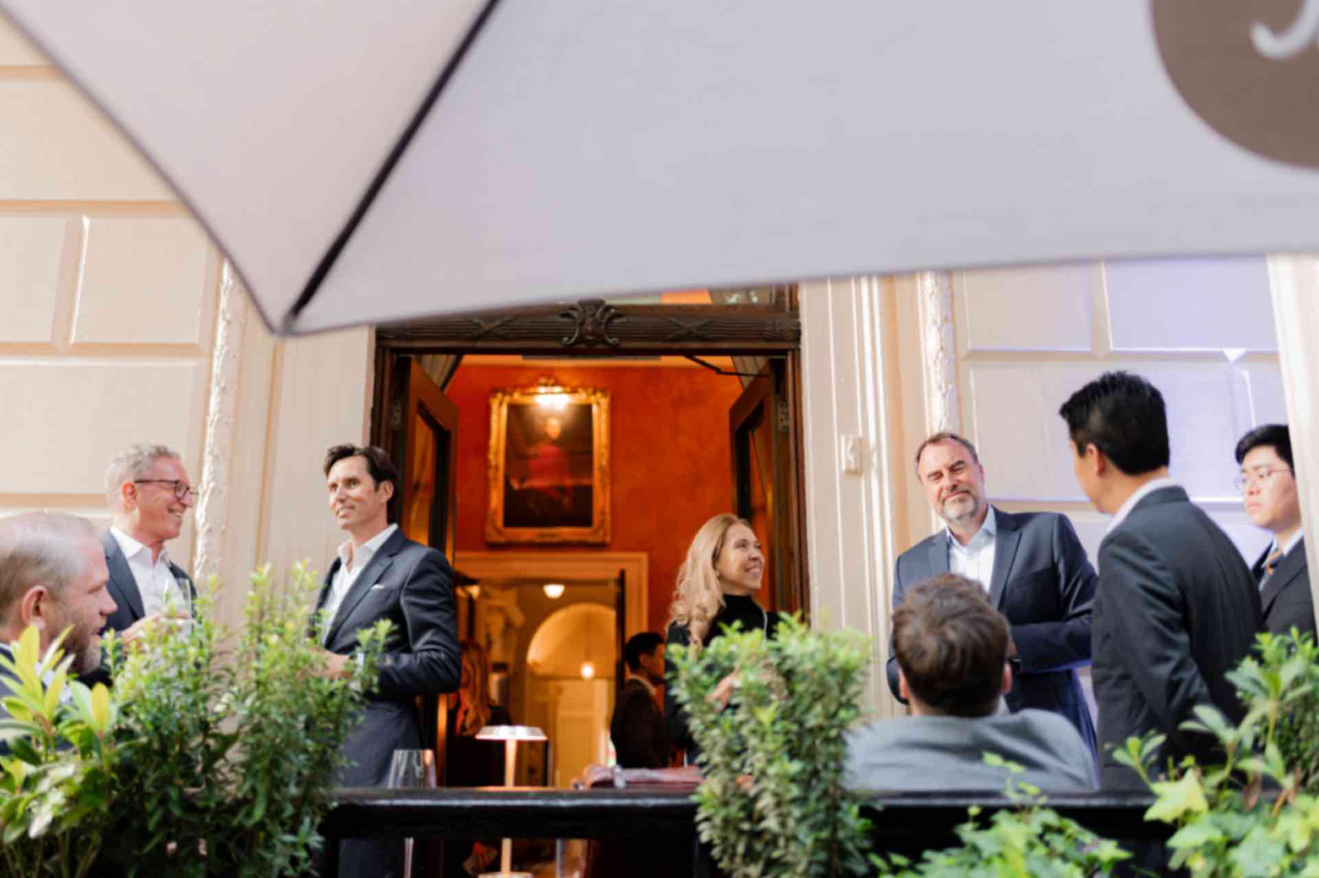 Sophisticated networking event in Carlton Room, 116 Pall Mall, with elegant decor and greenery.