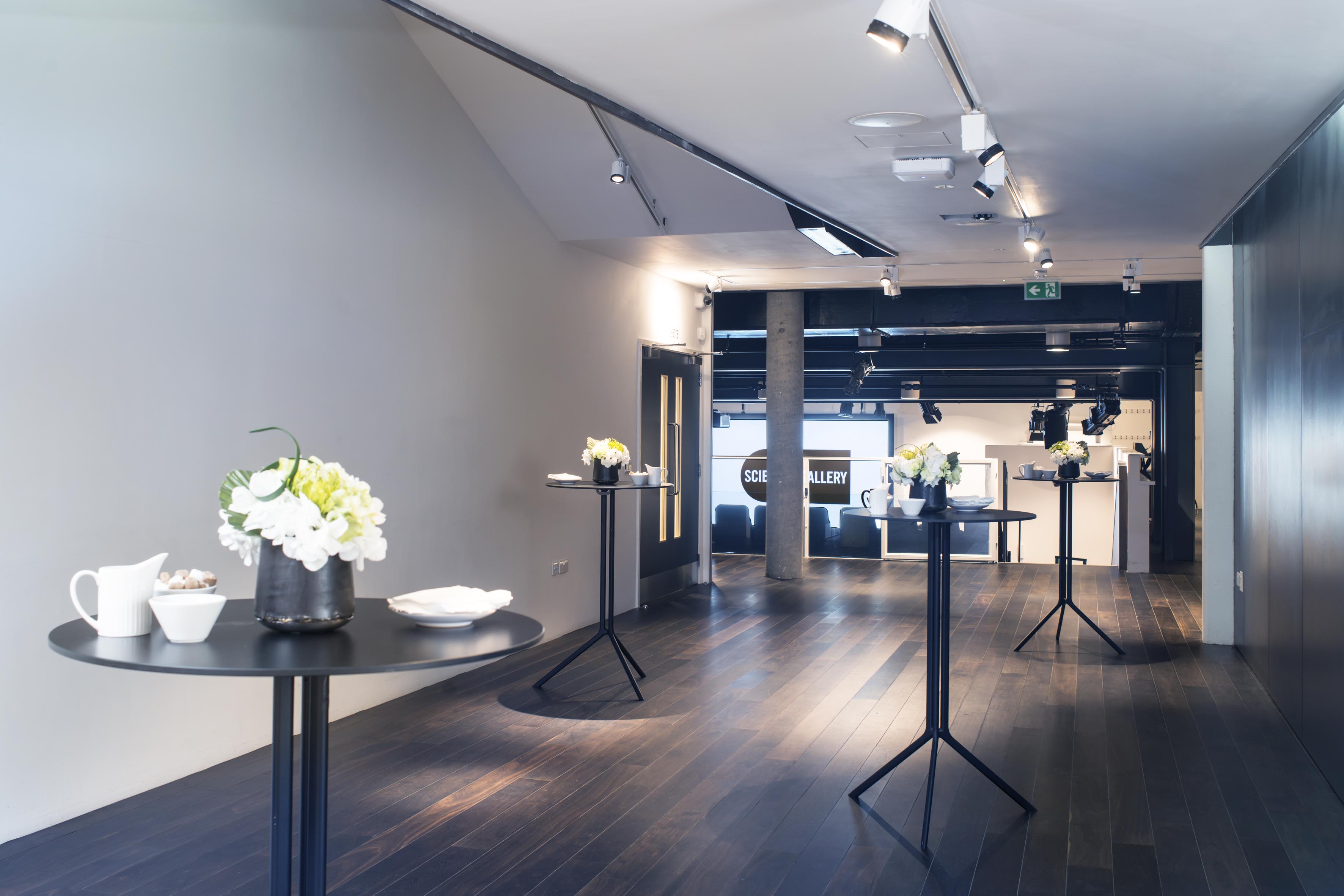 Modern event space in Science Gallery London with elegant floral arrangements for receptions.