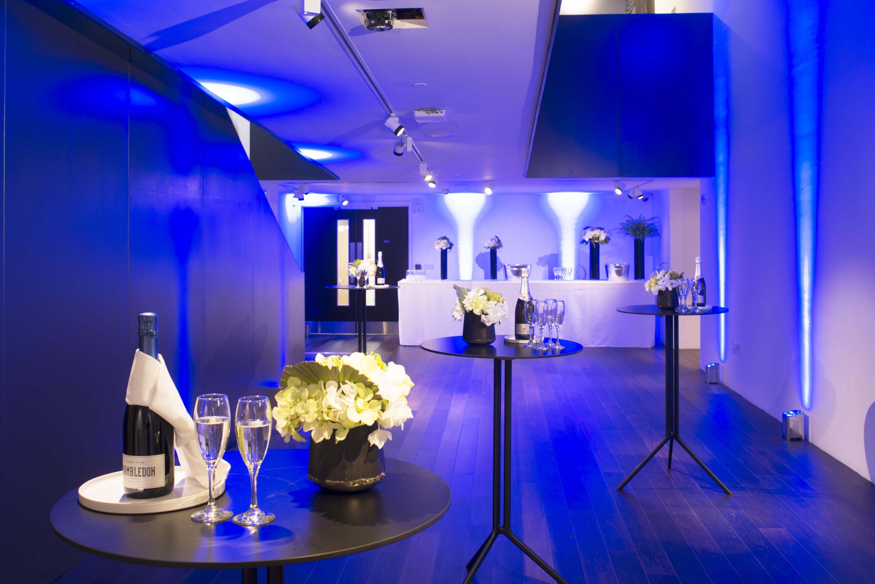 Modern event space in Science Gallery London with blue lighting for upscale receptions.