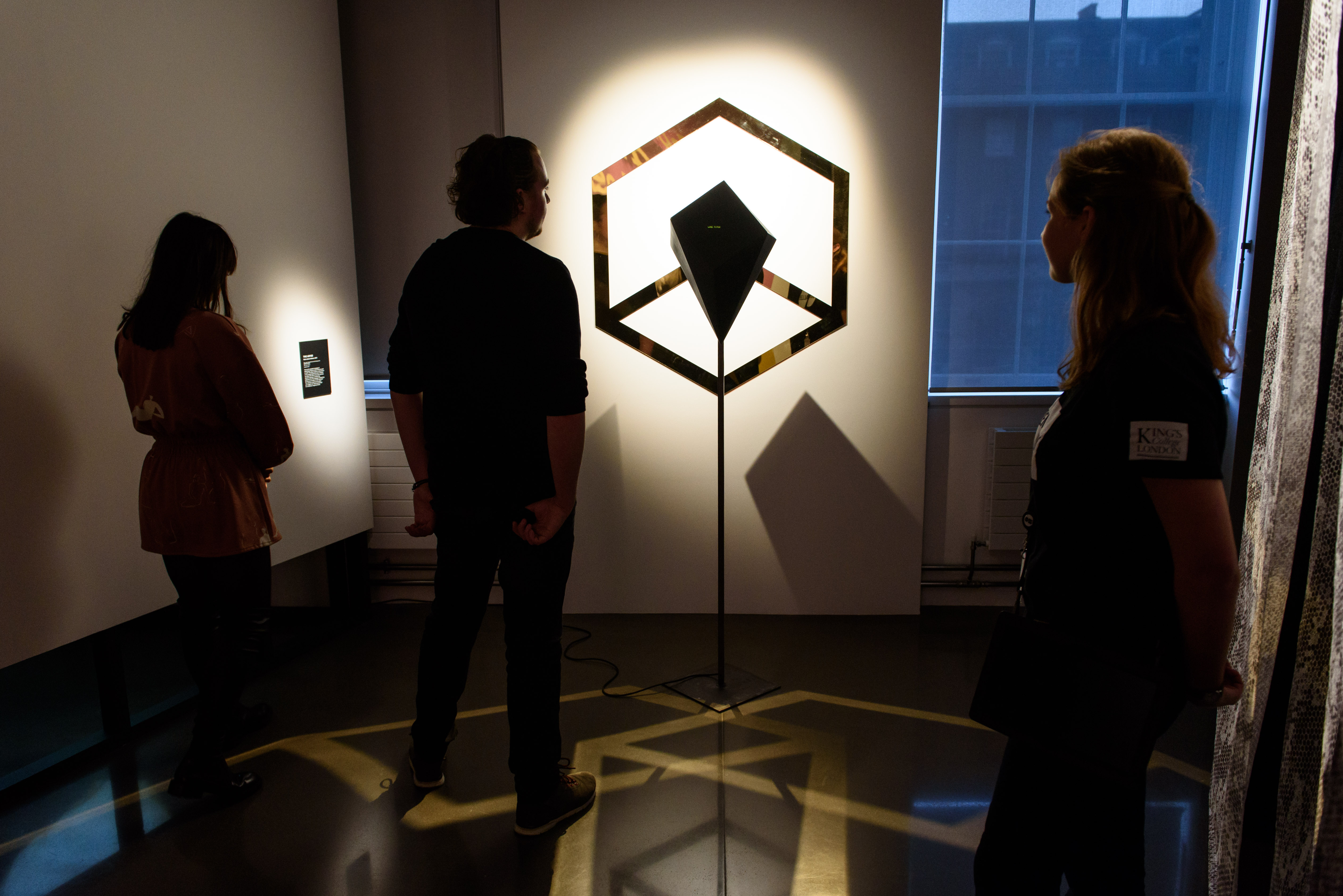 Attendees interact with art installation in modern Science Gallery London event space.