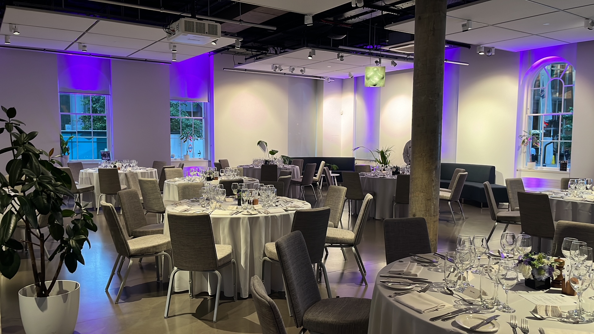 Ground Floor Space at Science Gallery London, elegant dinner setup with purple lighting.