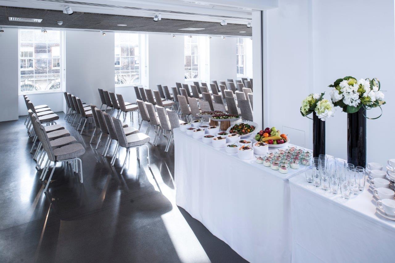 Event space in Science Gallery London with organized chairs and stylish refreshment table.
