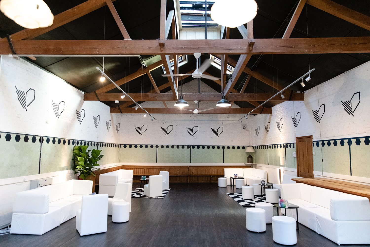 Modern event space in Park Village with high ceilings, ideal for gatherings and meetings.