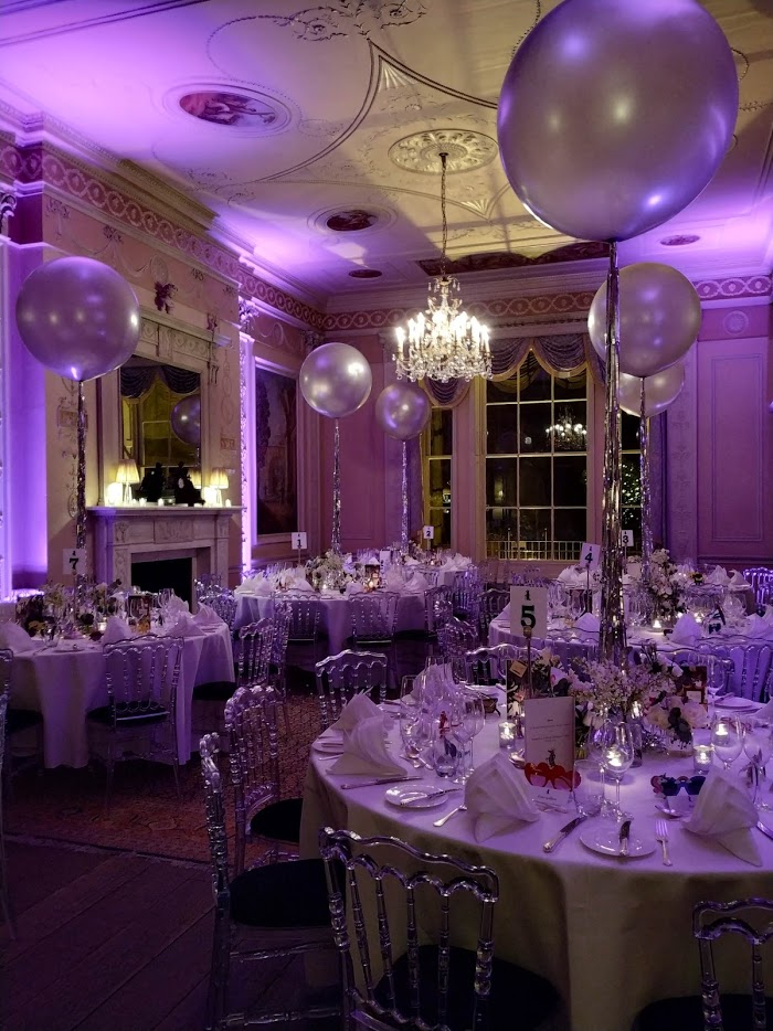 Elegant event space with tall balloons, perfect for weddings and corporate gatherings.