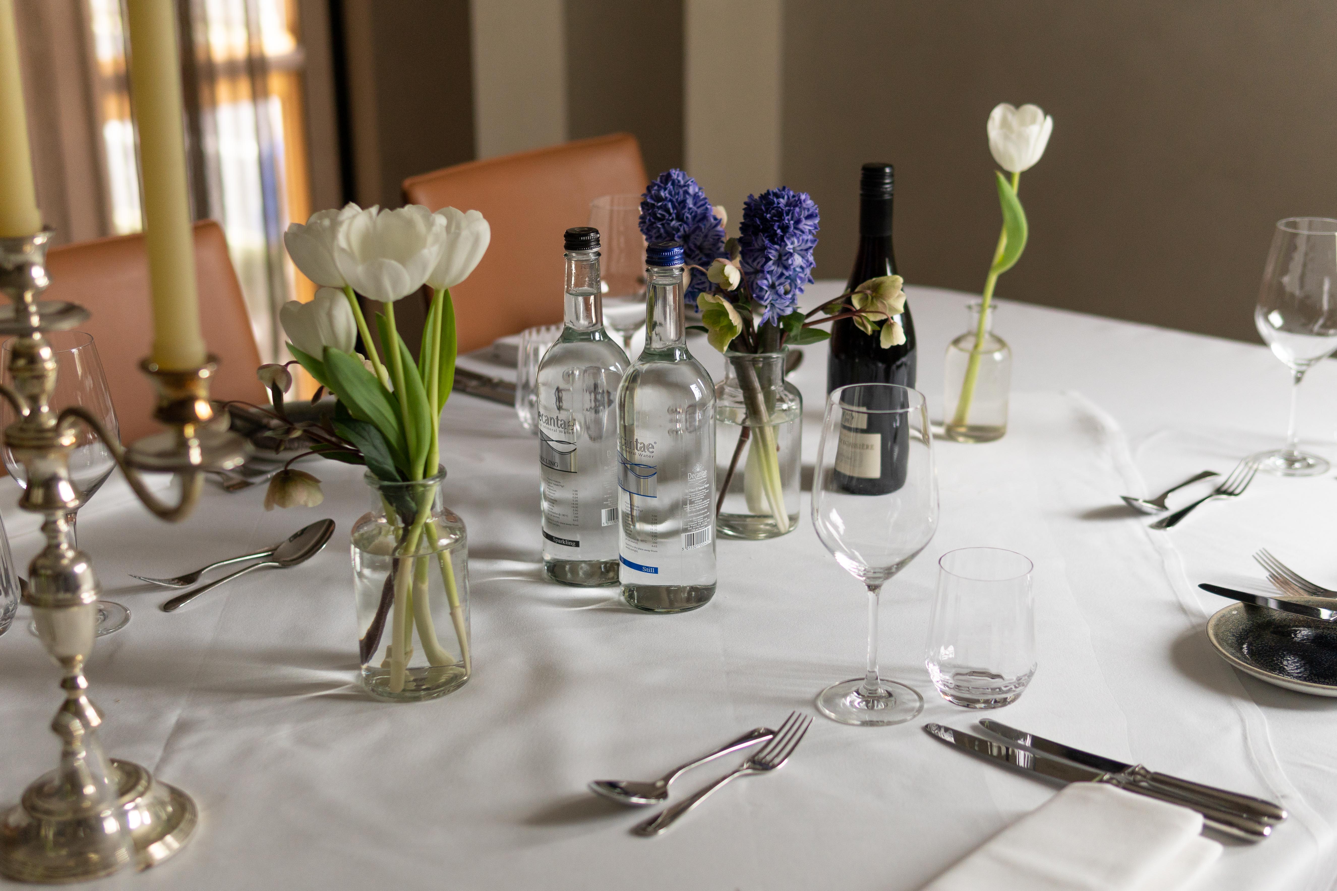Elegant table setting with floral arrangements for a refined event at The Athenaeum Hotel.