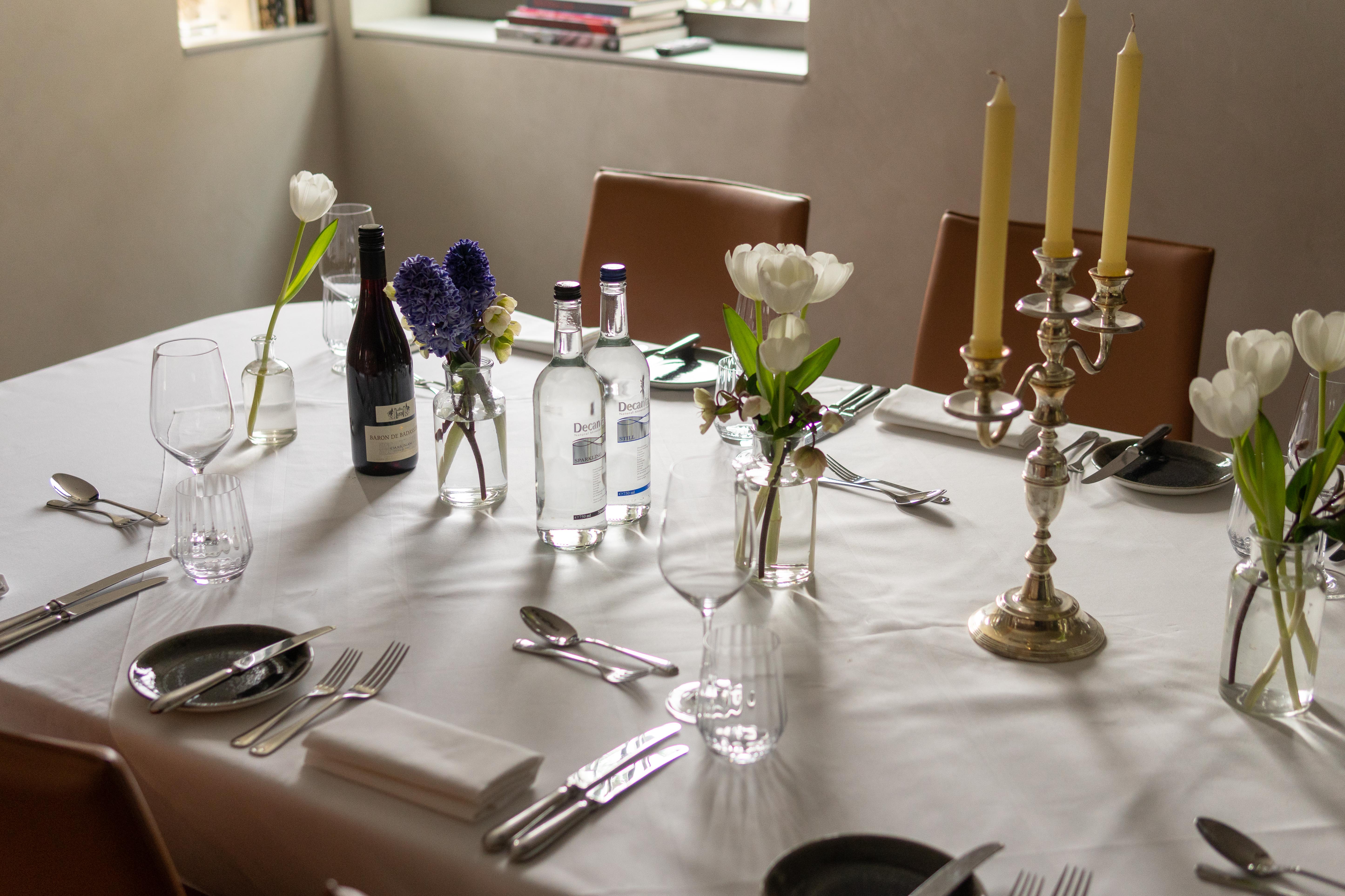 Elegant dining table with floral centerpieces at The Athenaeum Hotel for events.