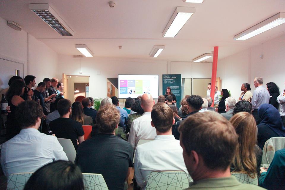 Engaged attendees in a modern conference space at Allia Future Business Centre, East London.