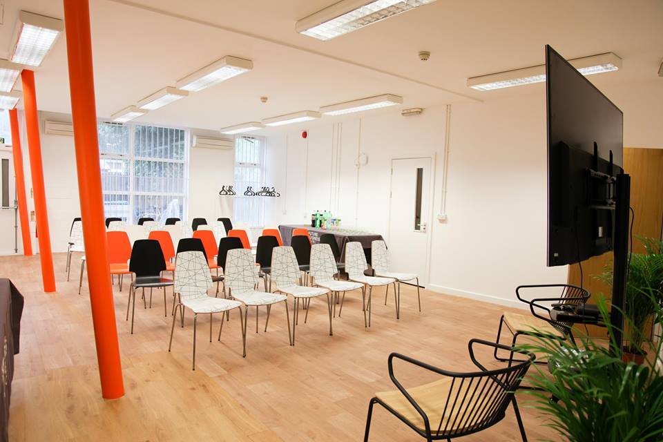 Modern conference space with colorful chairs for engaging workshops in East London.