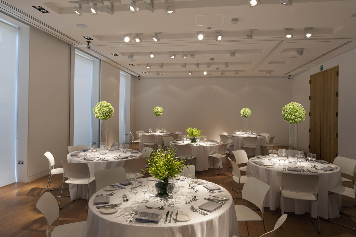 Elegant dinner setup in The Goldsmiths' Centre with round tables and lush centerpieces.