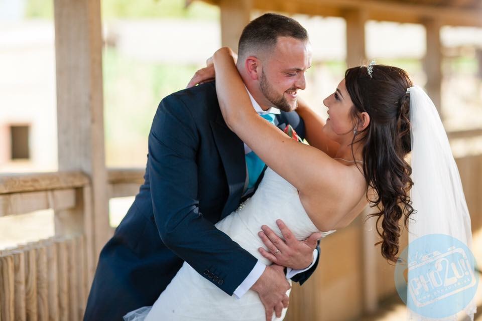 Joyful couple celebrating wedding at Woburn Safari Lodge, perfect outdoor venue for events.