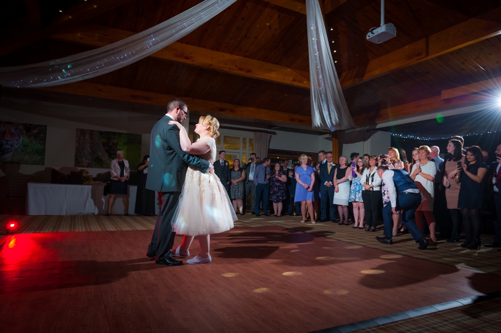 Couple's first dance at Woburn Safari Lodge wedding reception with warm ambiance.