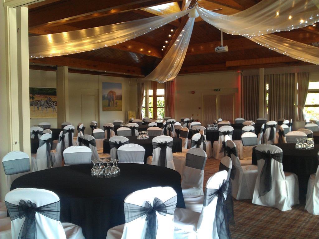 Elegant event space at Woburn Safari Lodge with black and white decor for formal gatherings.