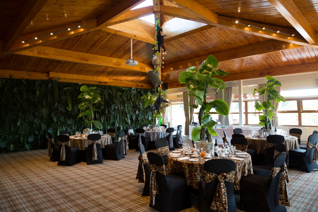 Elegant event space at Woburn Safari Lodge with round tables, ideal for weddings and parties.