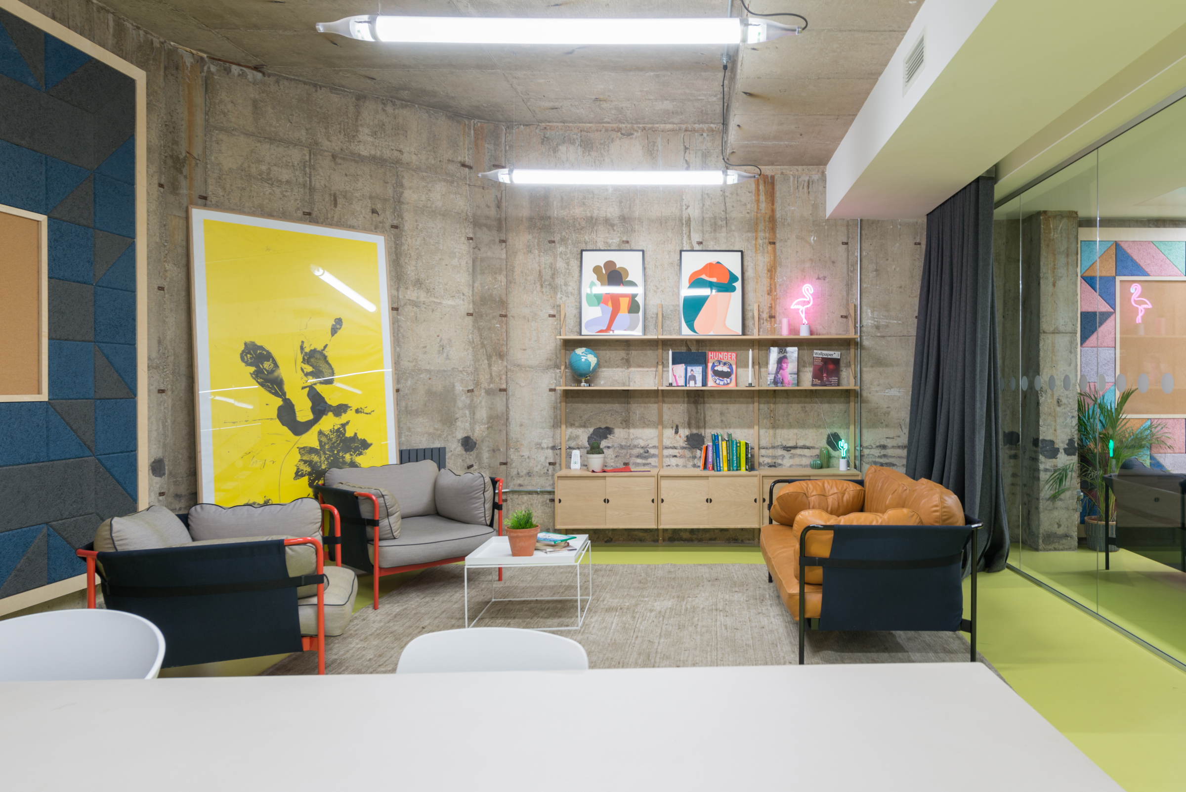 Modern meeting room with vibrant artwork, perfect for brainstorming and team collaboration.