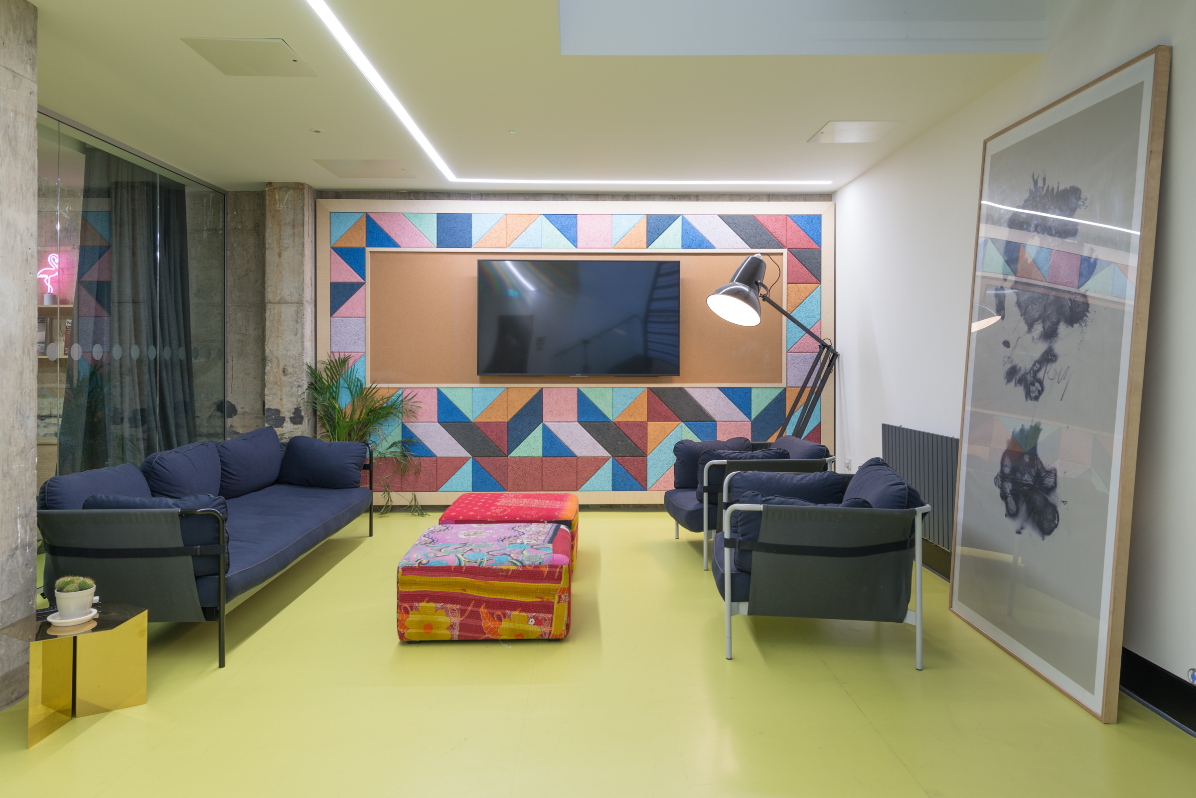 Modern meeting room with colorful geometric wall for creative brainstorming sessions.