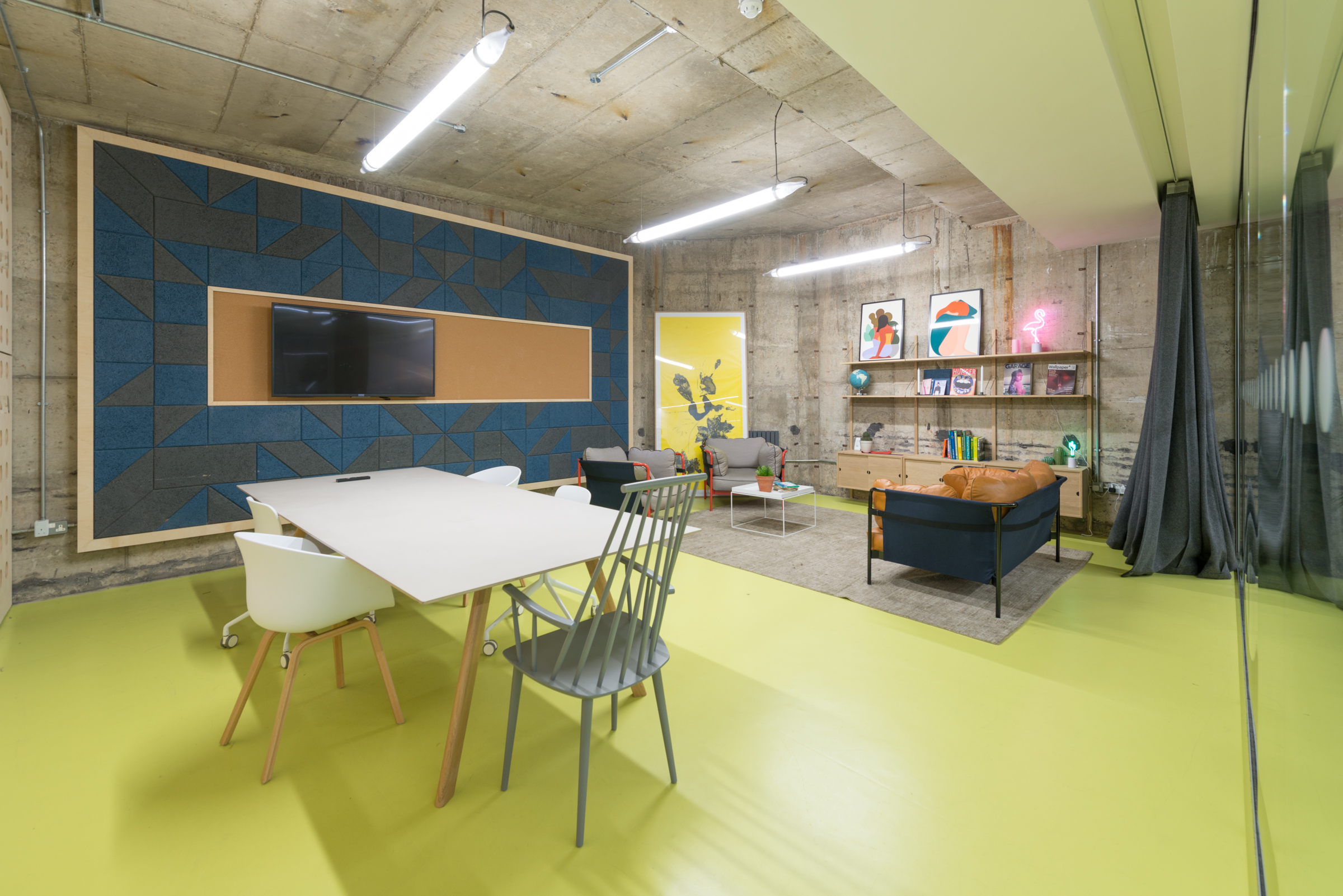 Modern meeting room with bright yellow flooring for creative collaboration and presentations.