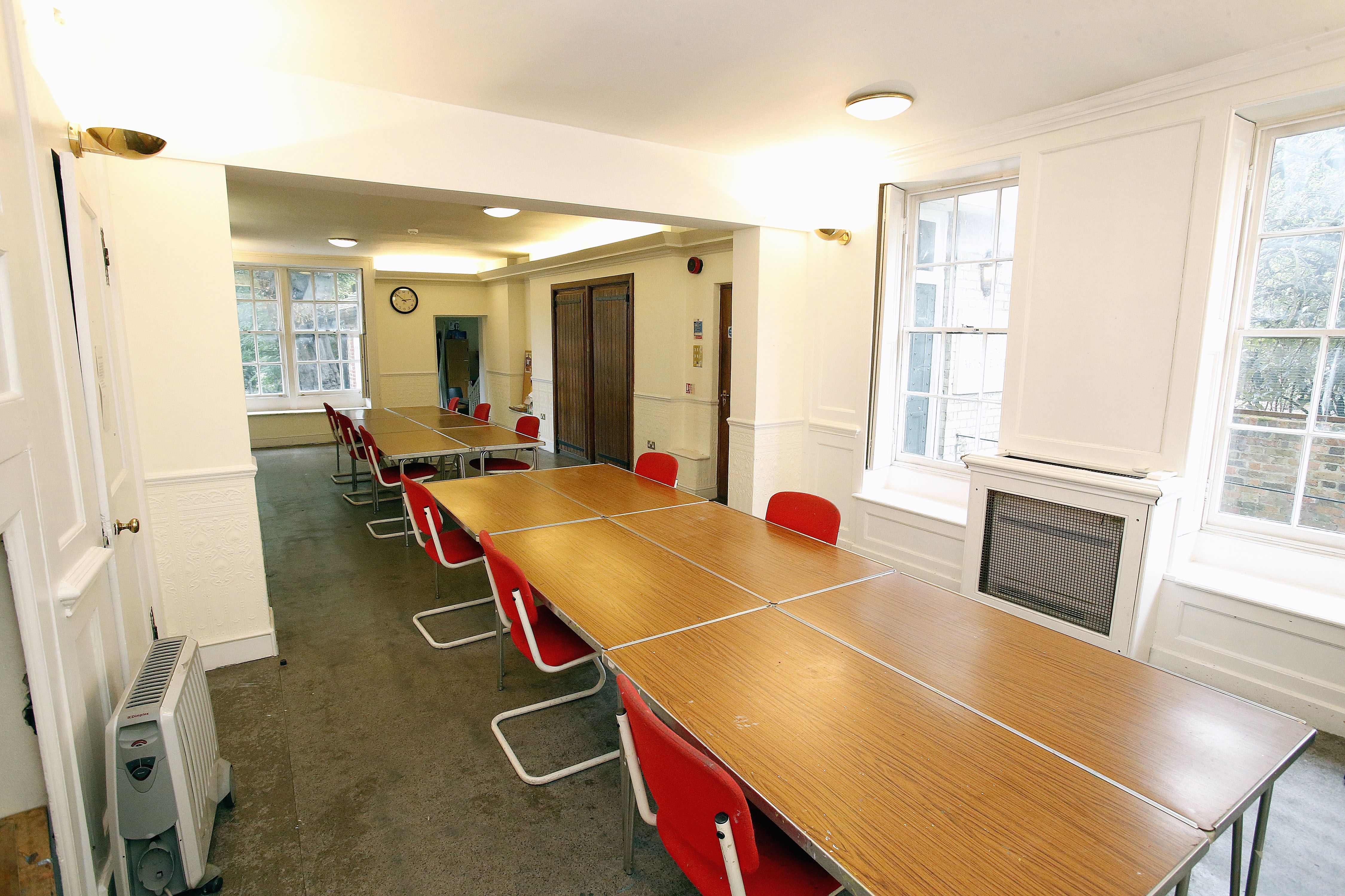 Ground Floor Salisbury Room with long table and red chairs, perfect for meetings and workshops.