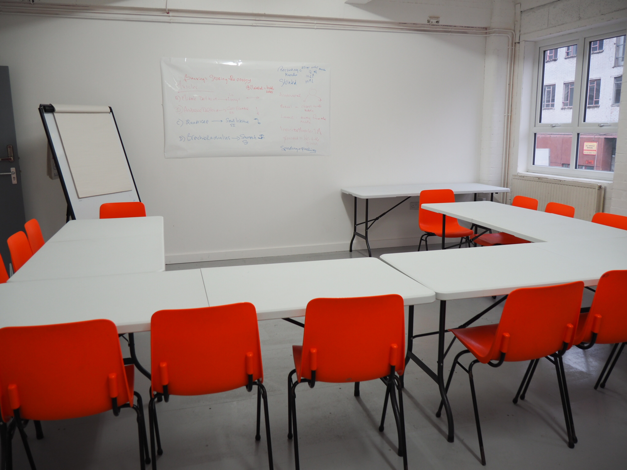 Versatile Wick Lane Studio meeting space with U-shaped table for workshops and discussions.