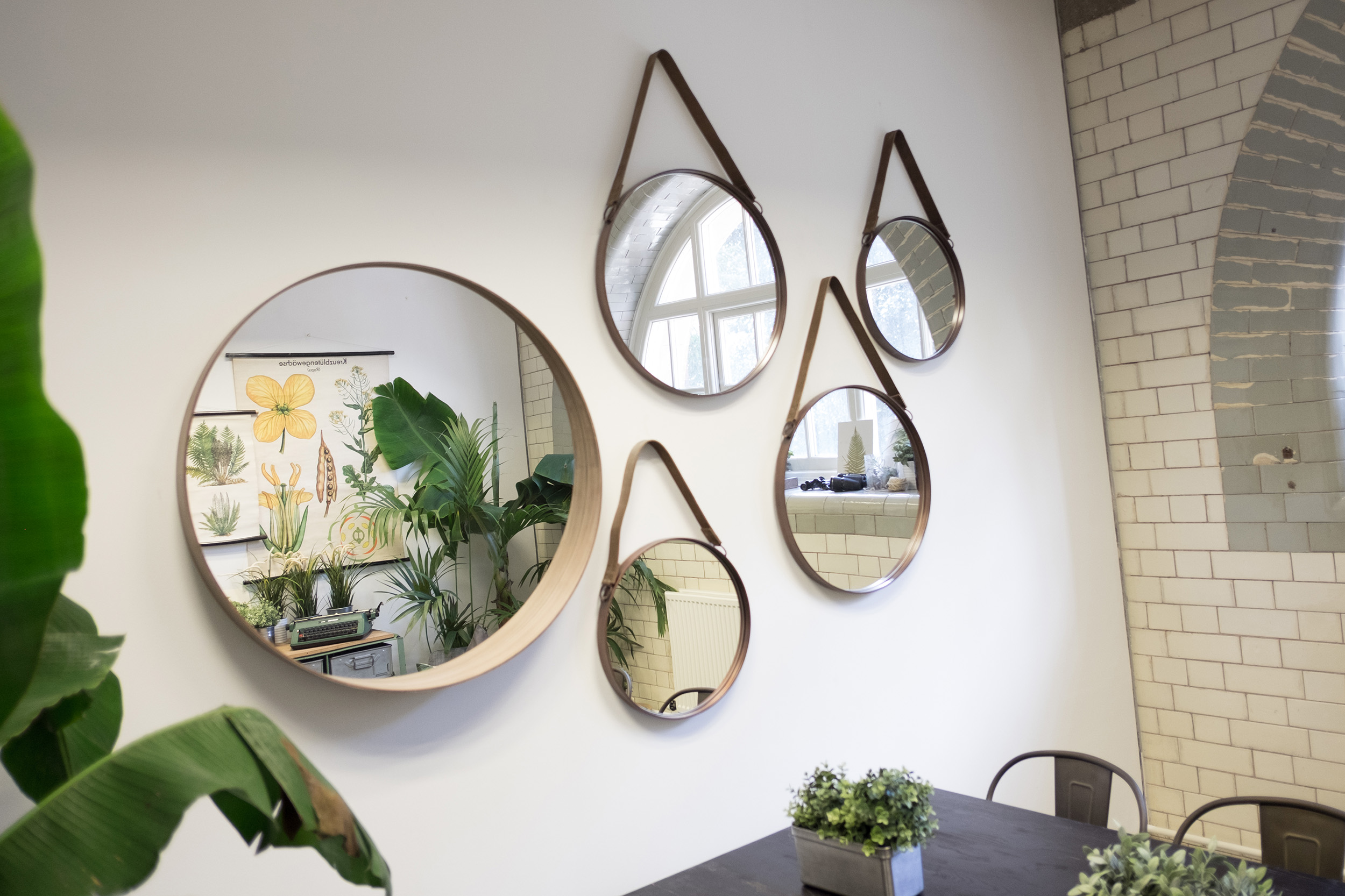 Stylish meeting space with mirrors and greenery for creative events at The Pumping House.