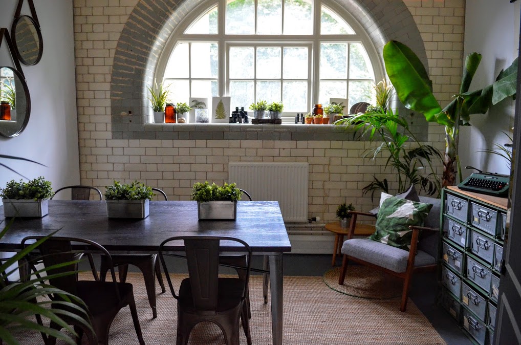 Stylish meeting space with natural light and greenery for creative gatherings at The Pumping House.