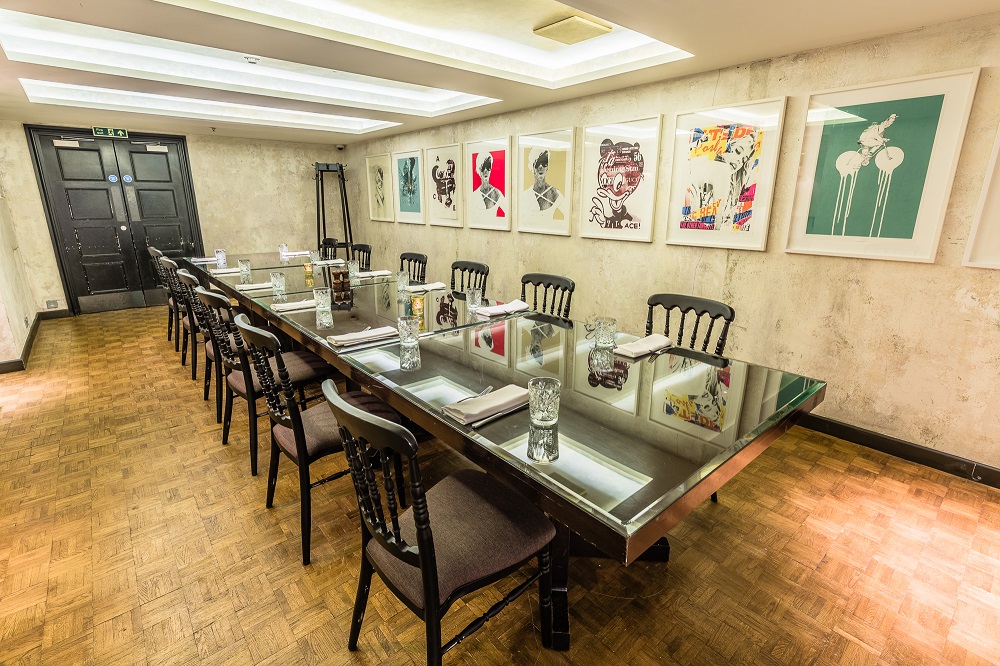 Modern meeting room with reflective table at Bread Street Kitchen, ideal for events.