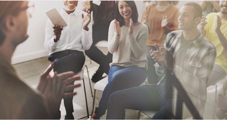 Engaged audience applauding at an event in The Pumping House, showcasing positive energy.