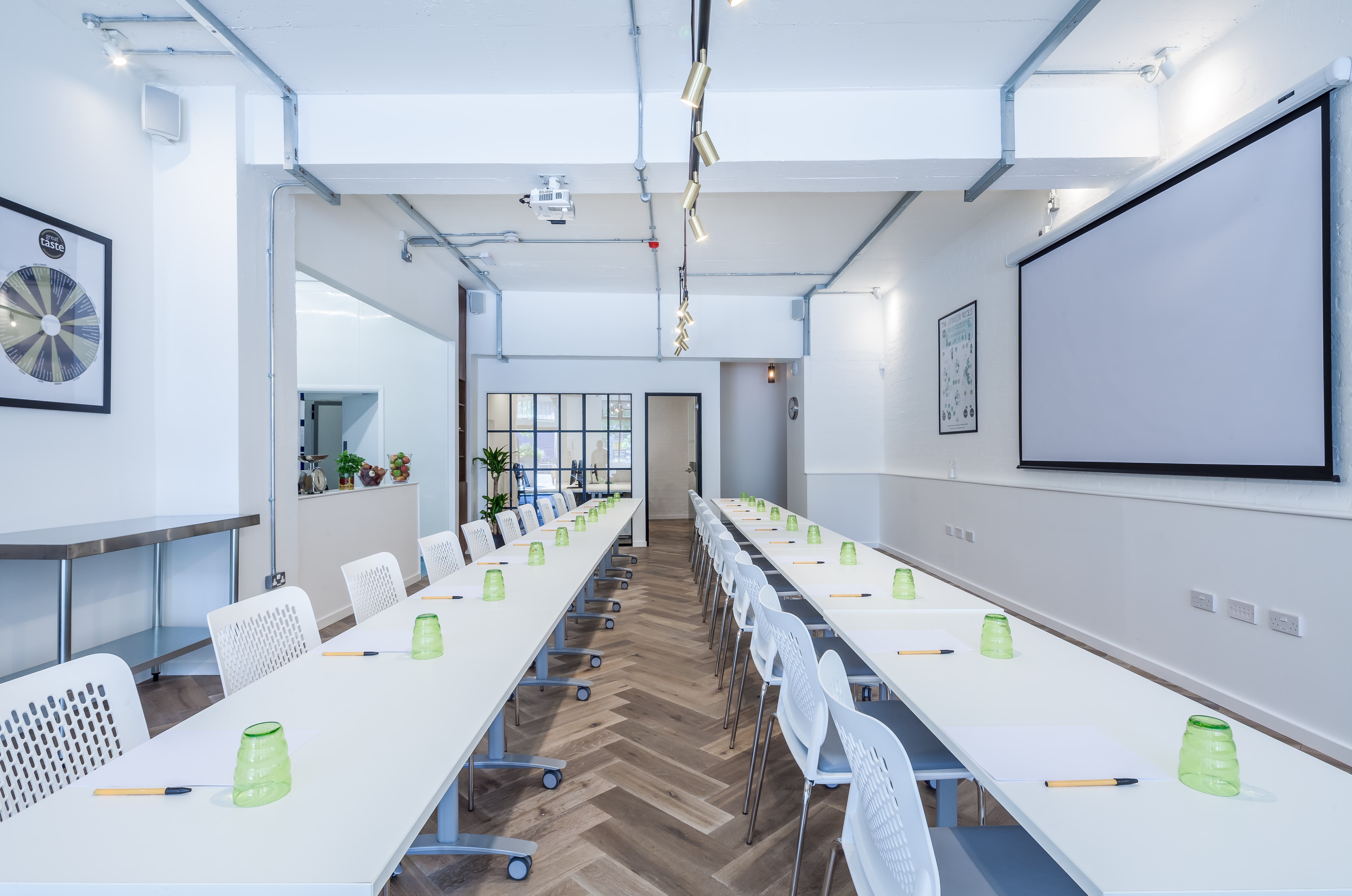 Modern meeting space with U-shaped tables for corporate workshops and presentations.