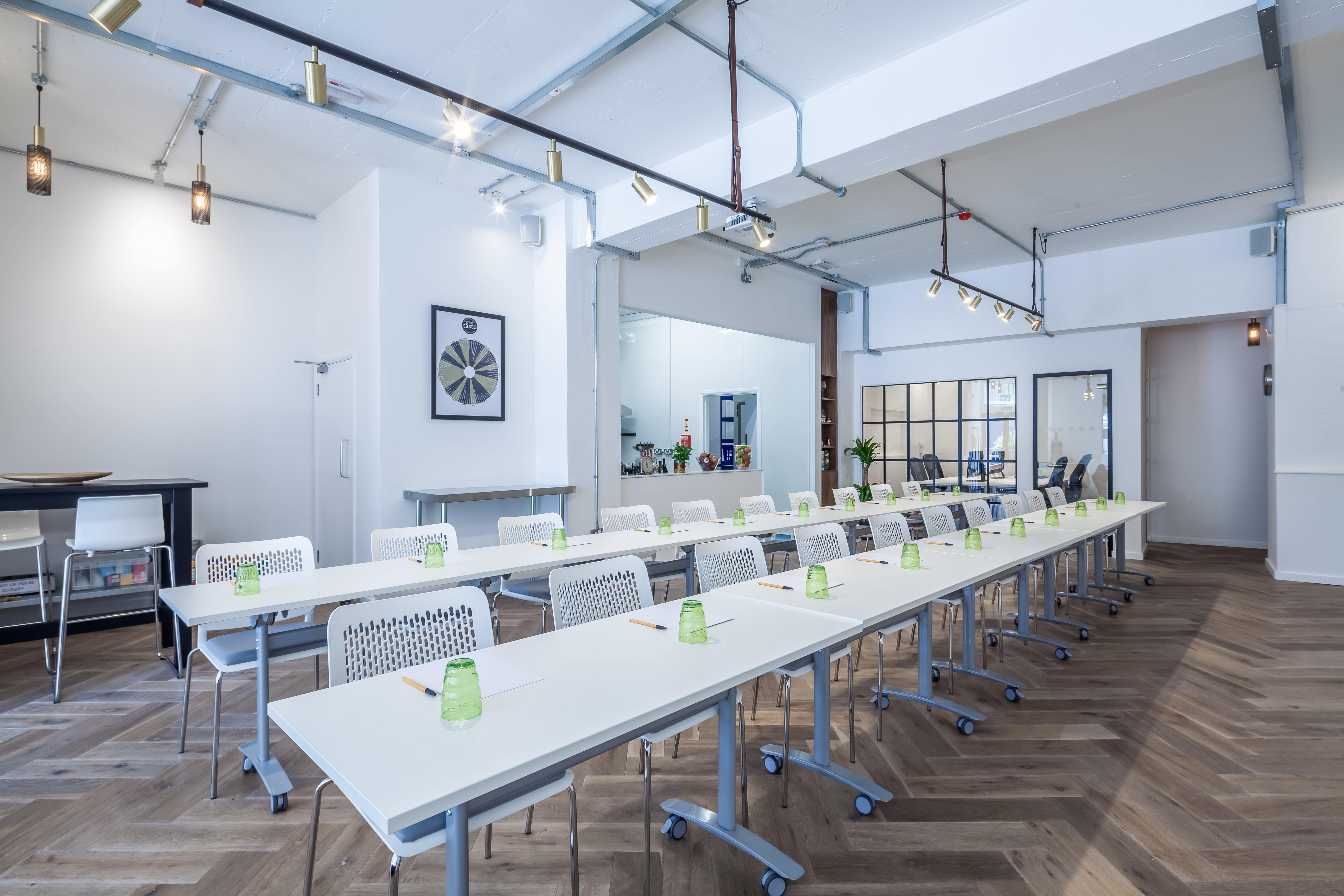 Modern meeting space with long tables, ideal for workshops and training sessions.