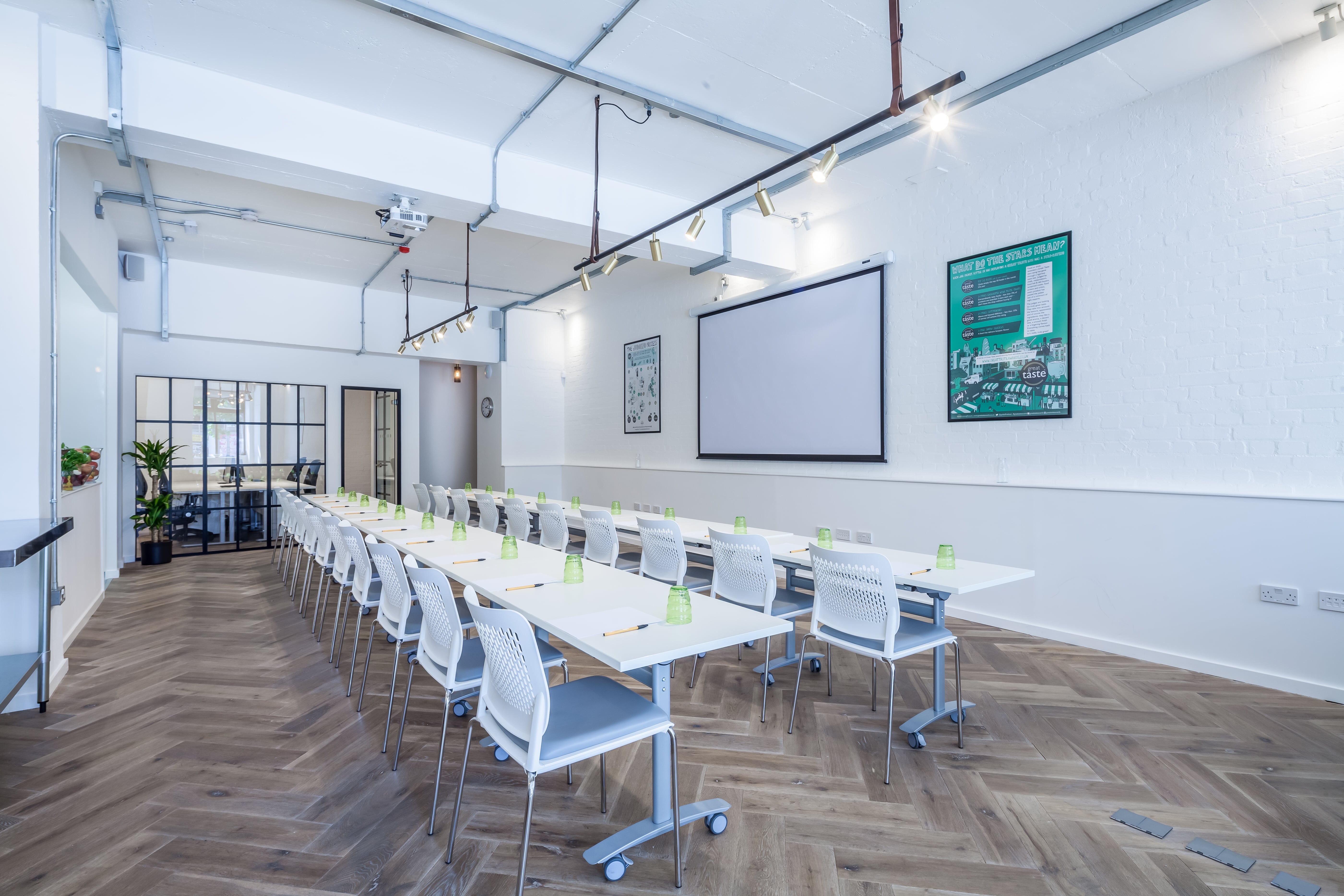Modern meeting room with long table, ideal for professional gatherings and events.