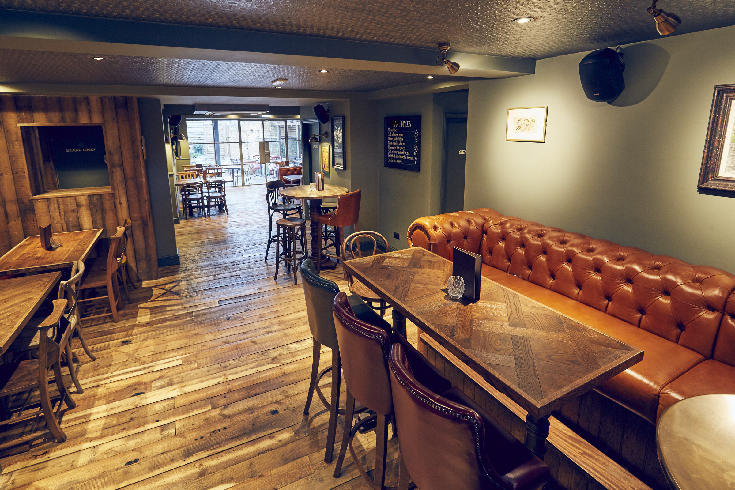 Versatile event space with wooden flooring at East Putney Tavern for meetings and gatherings.
