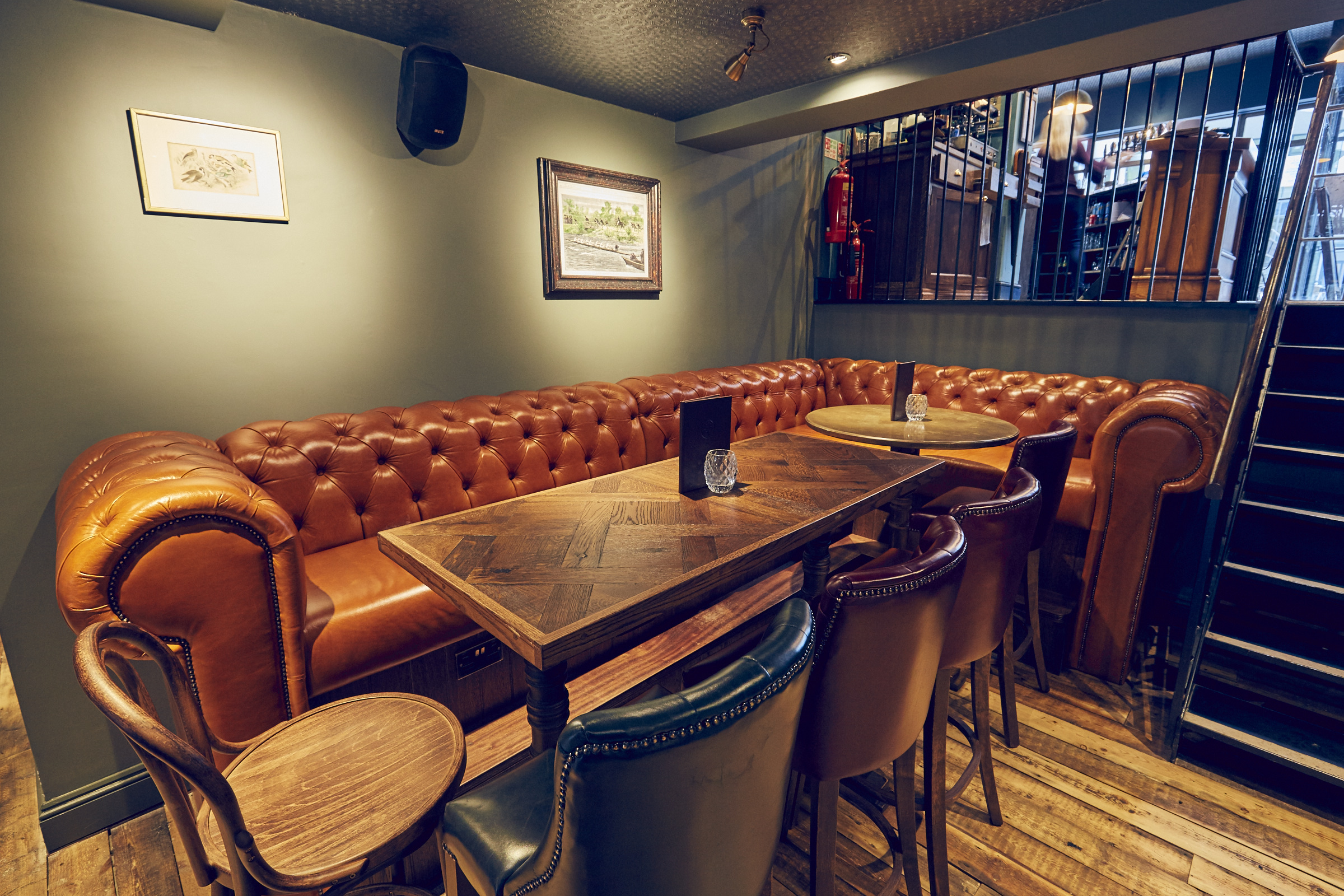 Cozy meeting space with leather sofa at East Putney Tavern for informal gatherings.