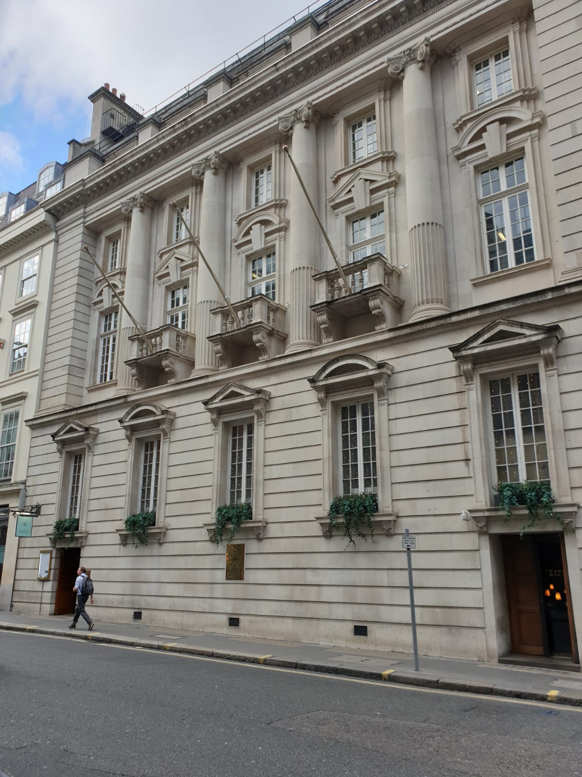 Elegant venue with columns and balconies for upscale corporate events and gatherings.