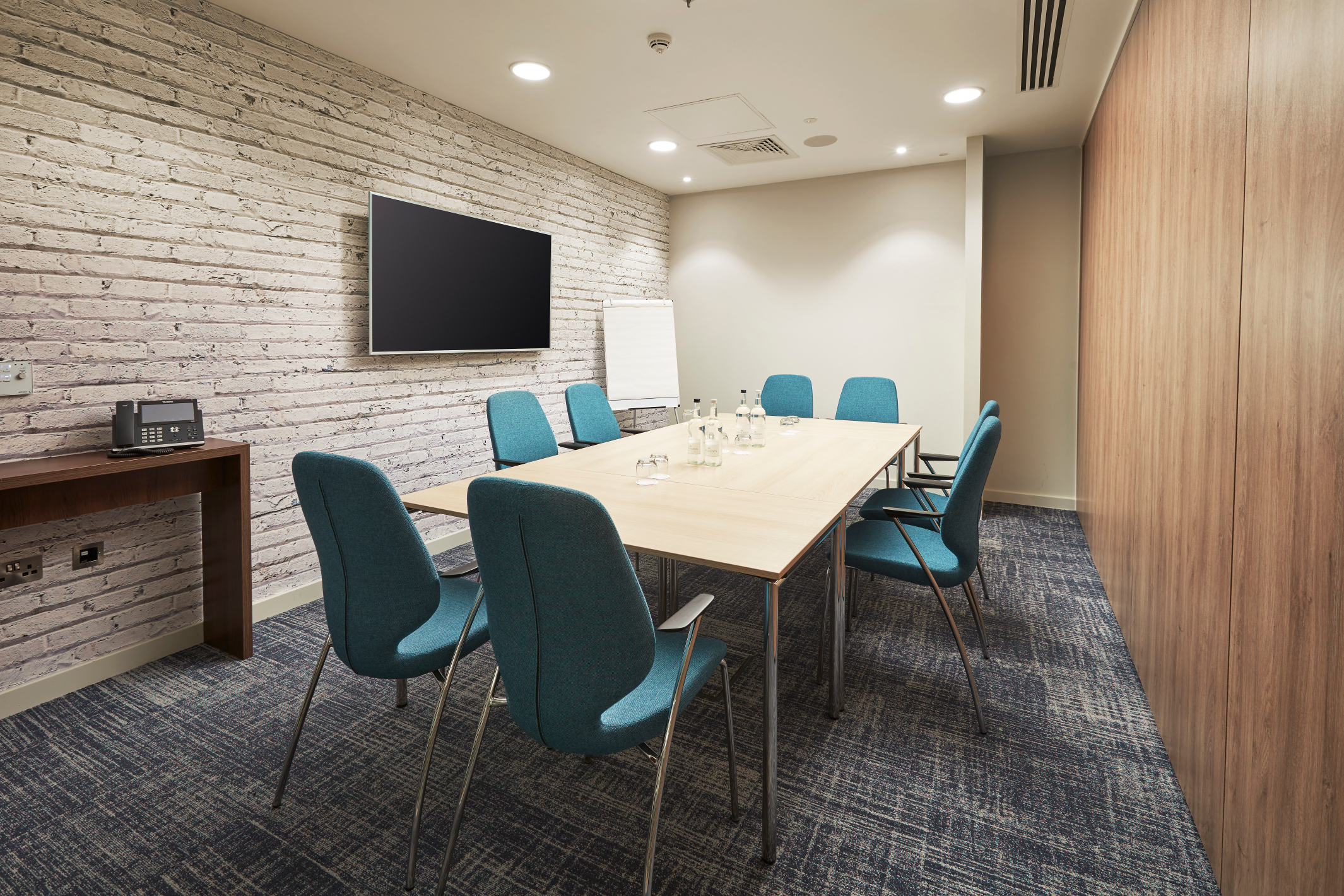Modern meeting room in Waterloo with rectangular table, perfect for collaboration events.