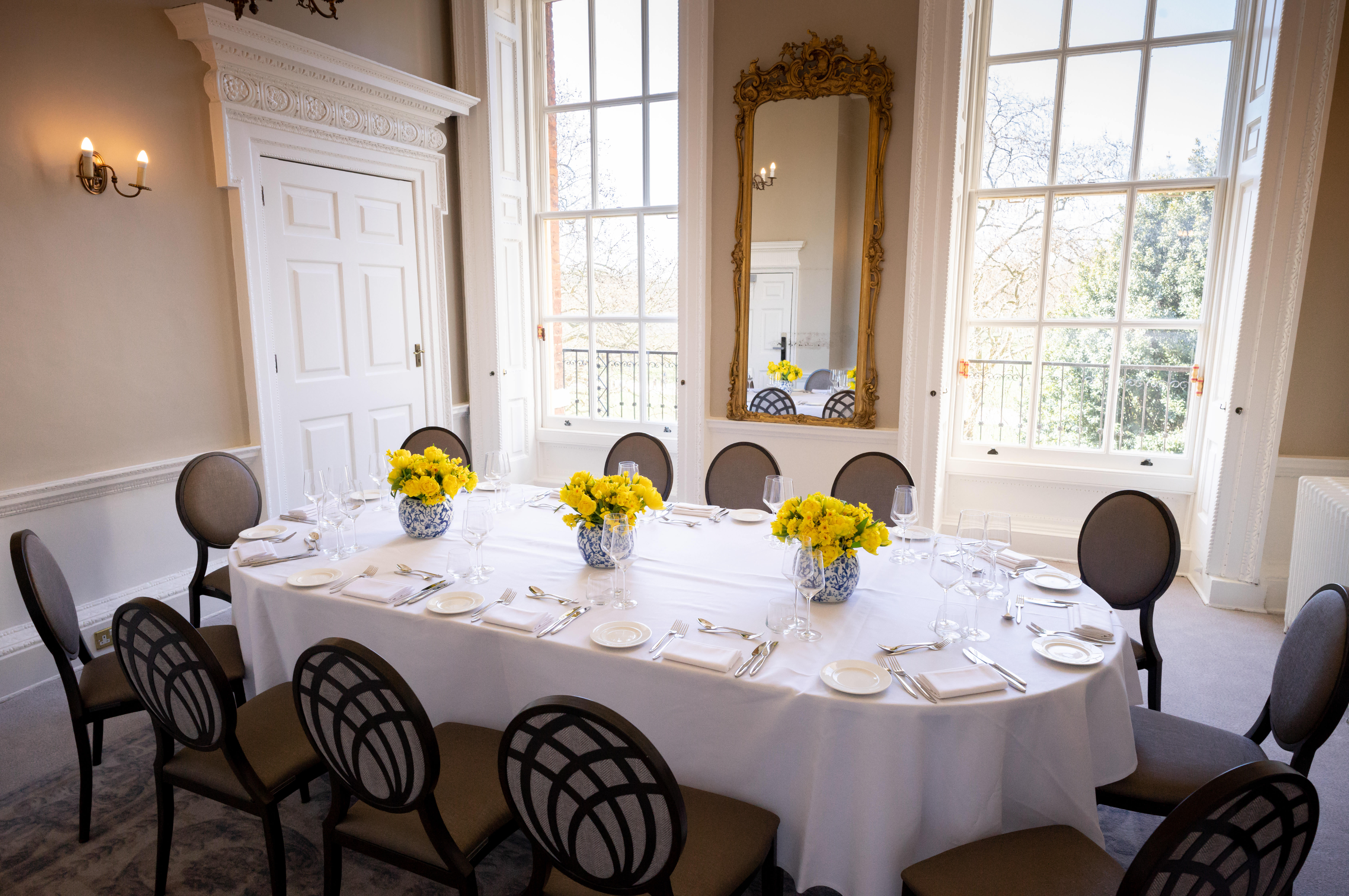 Elegant dining table with yellow flowers in Bennet-Clark Room for upscale events.
