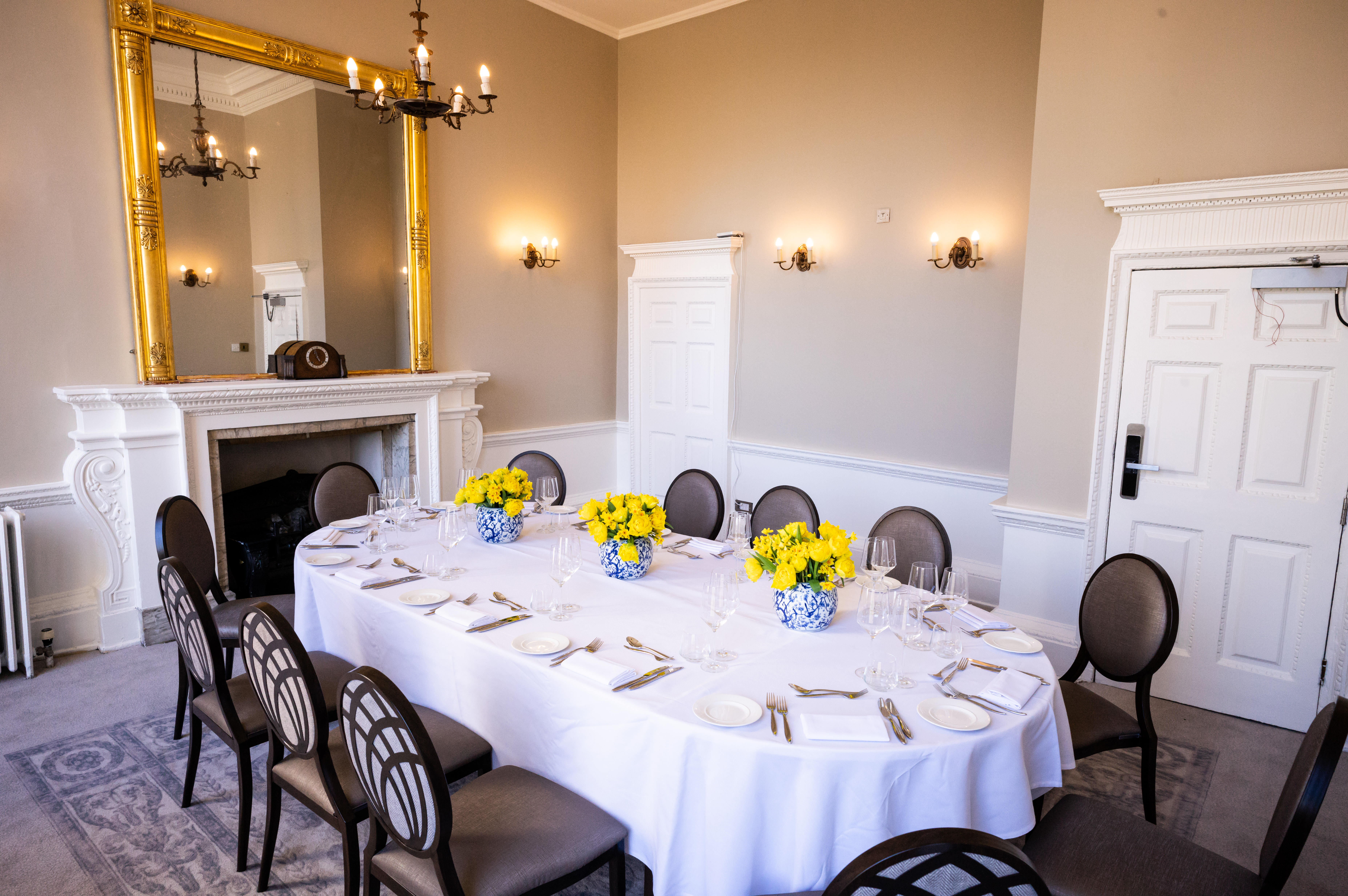 Elegant dining room with floral centerpieces for corporate dinners and private gatherings.