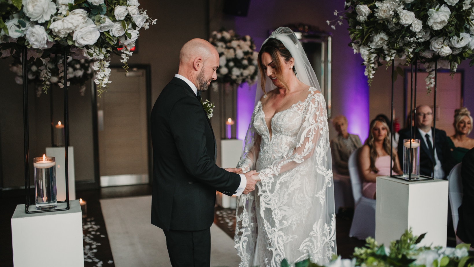 Elegant couple exchanging vows in Cunard Suite, romantic wedding ceremony decor.