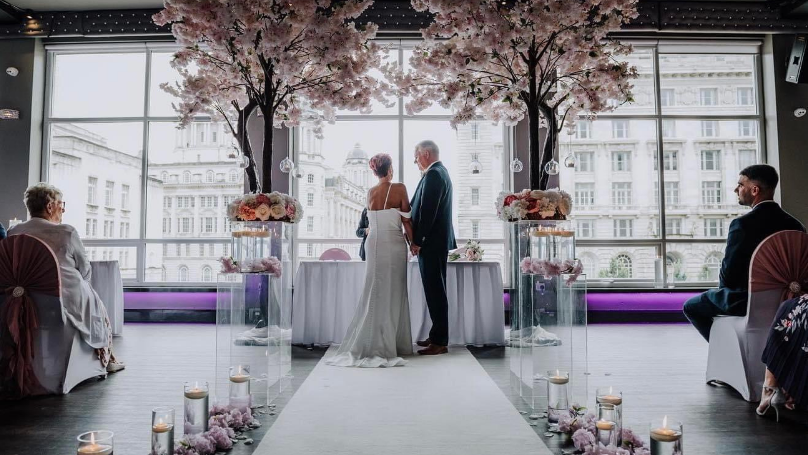 Cunard Suite wedding ceremony with cherry blossoms and elegant decor in urban setting.