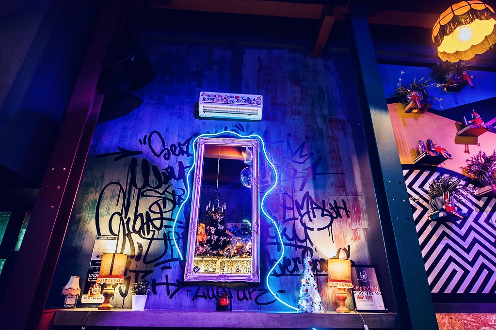 Vibrant Tank Room venue with graffiti backdrop for creative events and themed parties.