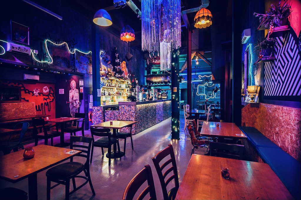 Vibrant Tank Room venue with colorful lighting for creative events and gatherings.