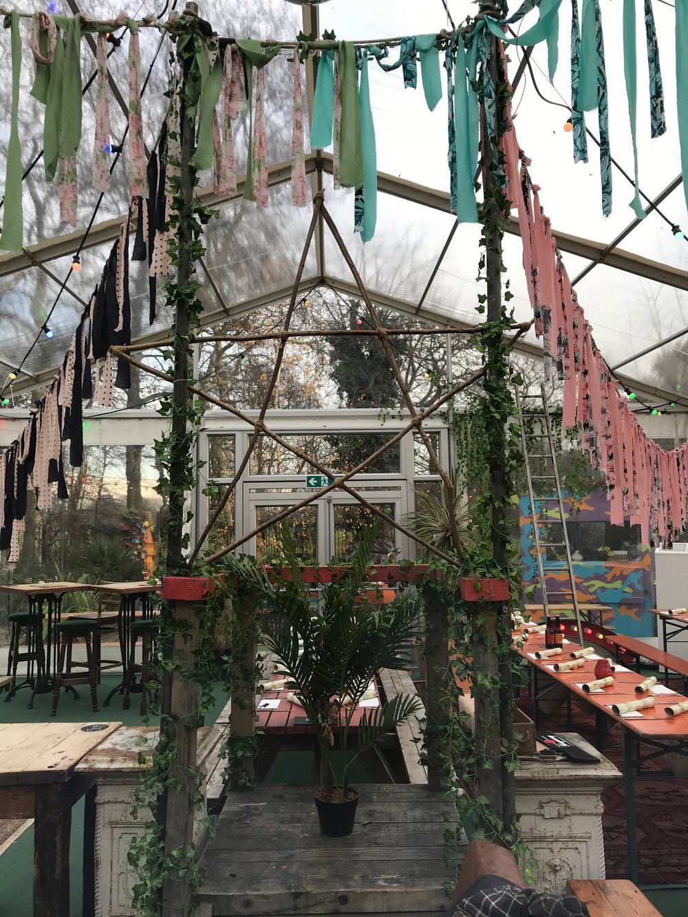 Transparent tent event space with greenery at Greenhaus, ideal for gatherings and celebrations.